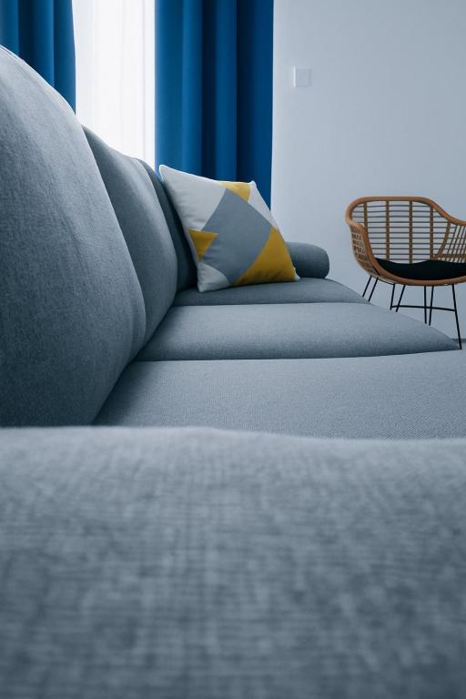 a blue couch with pillows on it in a room at 3 Mountains Luxury House in Aridaia