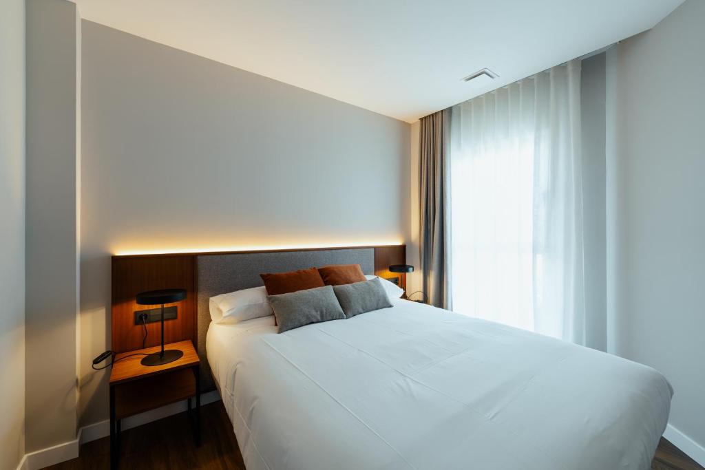 Postel nebo postele na pokoji v ubytování Apartamentos 2H LIVING