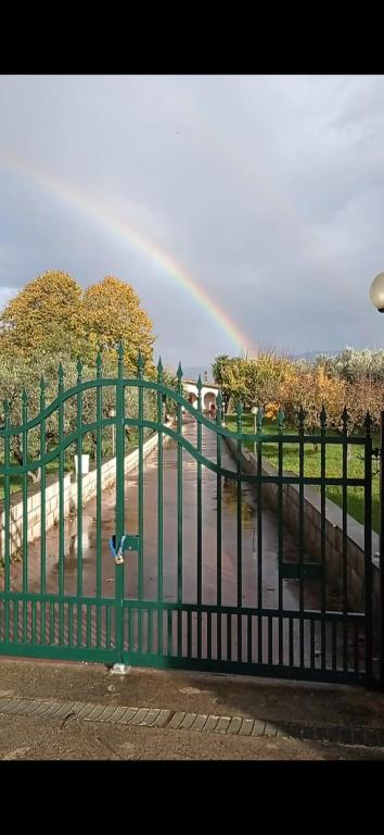 a rainbow in the distance with a fence with a fence at TABERNA ROMANA VILLA OCA b&b in Velletri