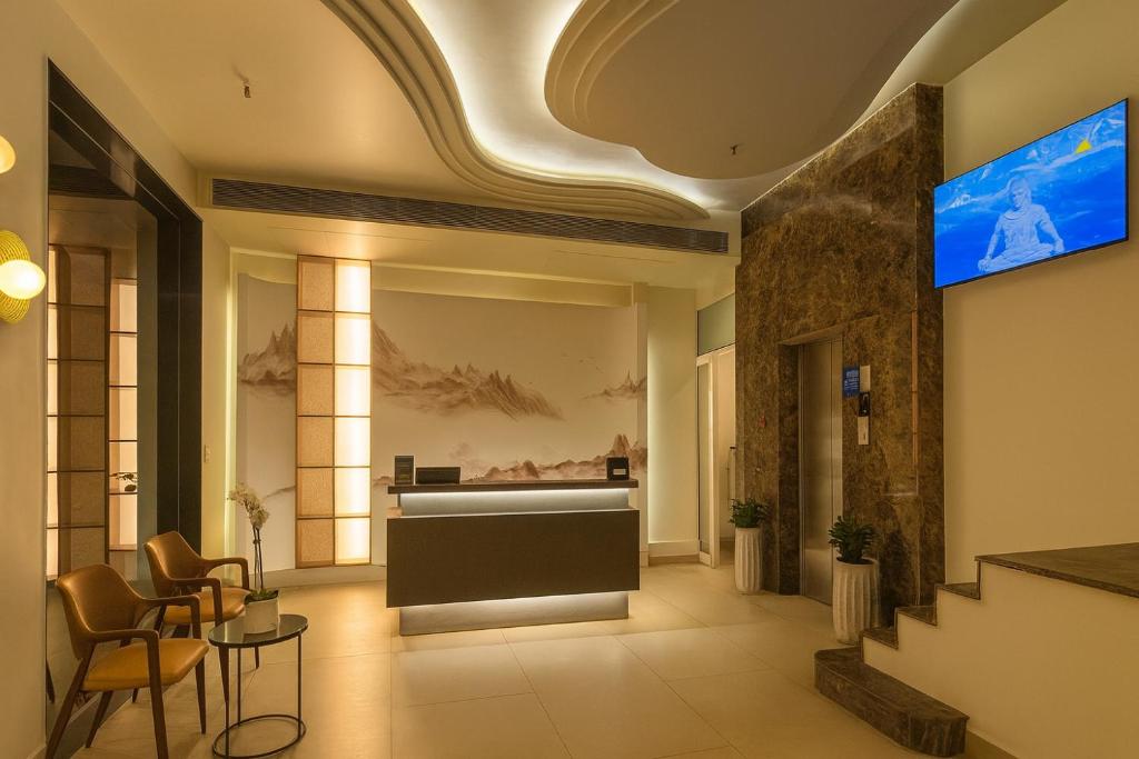 eine Lobby mit einer Rezeption und einem TV in der Unterkunft The Yuvraj By LIVIQ in Neu-Delhi