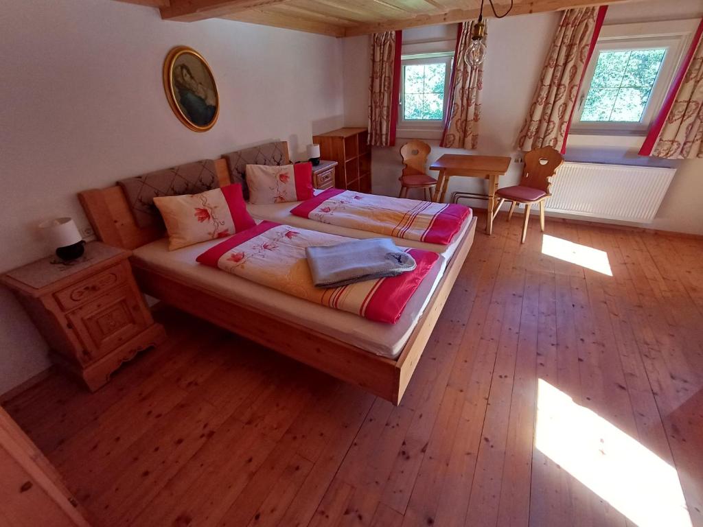 a bedroom with a bed and a table and chairs at Romantisches Bauernhaus in Sankt Veit im Pongau