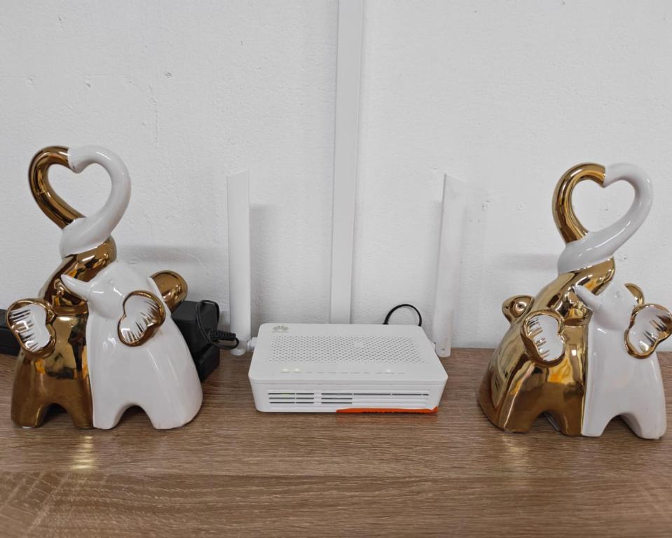 two metal figurines of two rabbits next to a laptop at Casa Little Italy in Boquerón