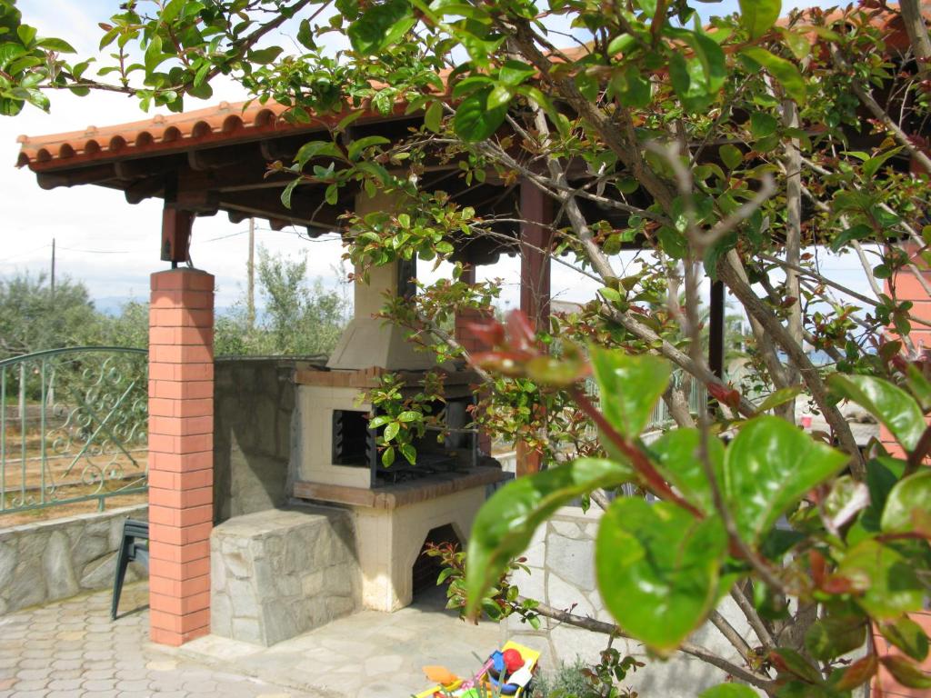 a outdoor oven with a roof on a patio at Seaview Aparthotel in Nea Potidaea