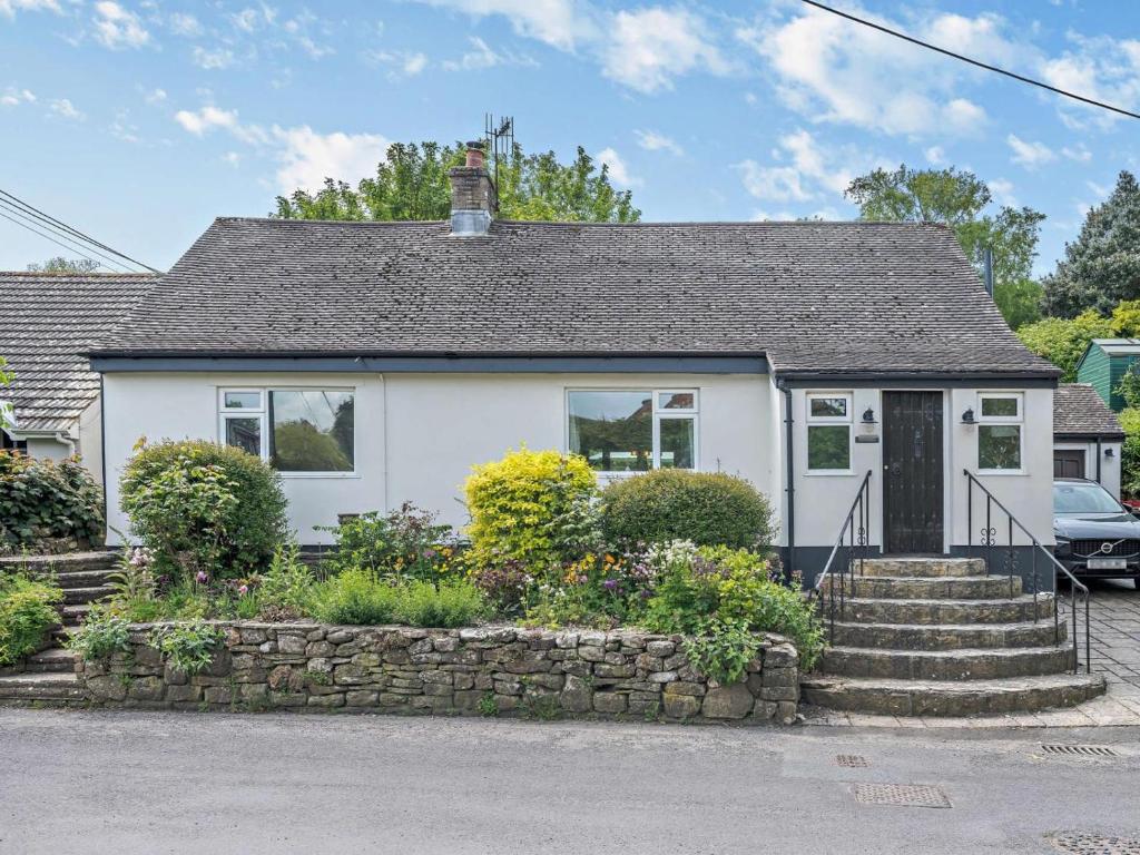 a white house with a stone wall at 5 Bed in Wareham oc-83036 in West Lulworth