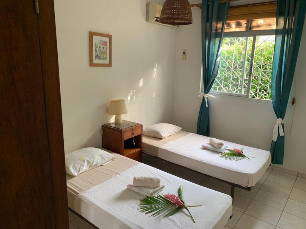 En eller flere senge i et værelse på Bungalow Corossol