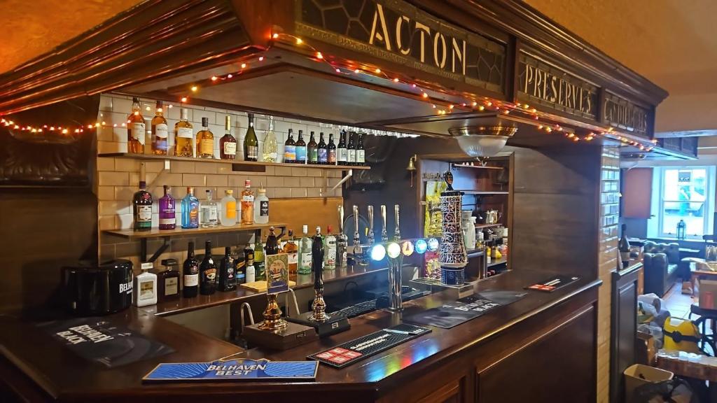 a bar with a lot of bottles of alcohol at The Wigtown Ploughman in Wigtown