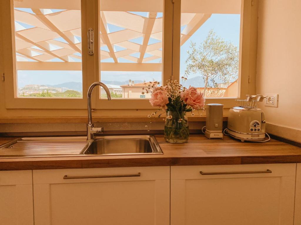 a kitchen counter with a sink and a window at Il giardino di Gaia in Portoferraio
