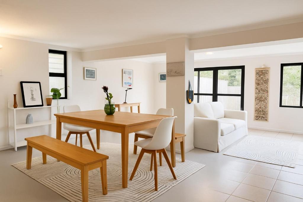 a living room with a table and chairs and a couch at Wildlife and Ocean Cottage in Scarborough