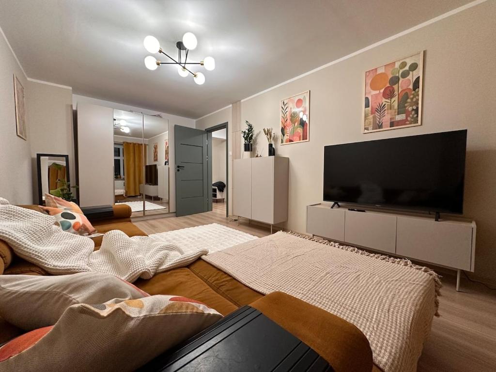 a living room with a large flat screen tv at Mieszkanie w centrum miasta in Kętrzyn