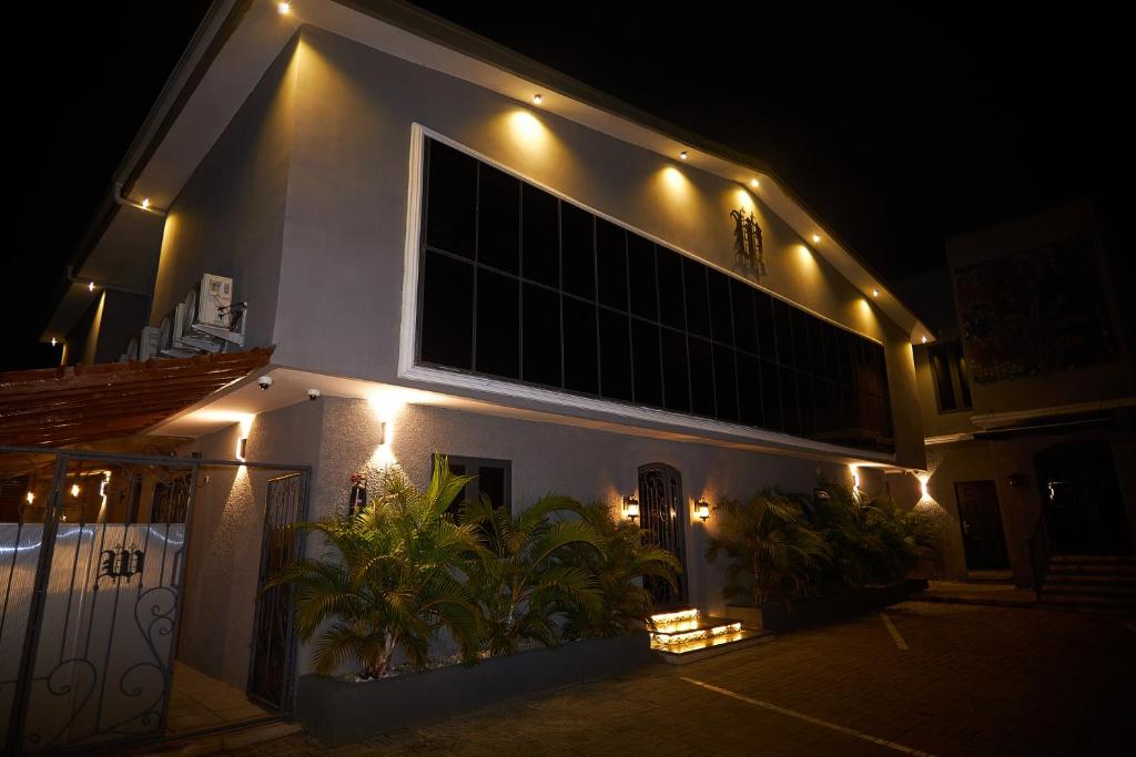 a white building with lights on it at night at The Westbury Inn in Abuja