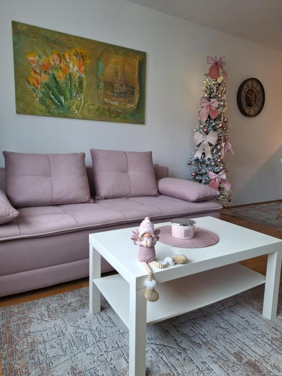 a living room with a couch and a table at Apartman Lory, Zagreb, Downtown, with own parking in the garage in Zagreb