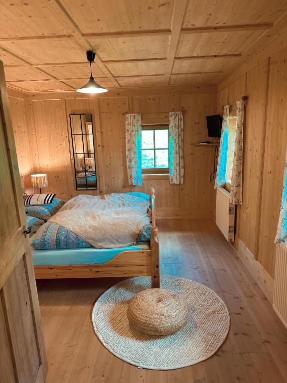 a bedroom with a bed in a wooden cabin at Ferienwohnung Eggerhof-Schaller in Innervillgraten