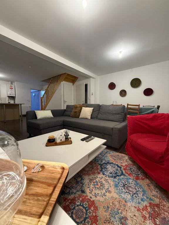 a living room with a couch and a table at MAISON SERENITY Bohars in Bohars