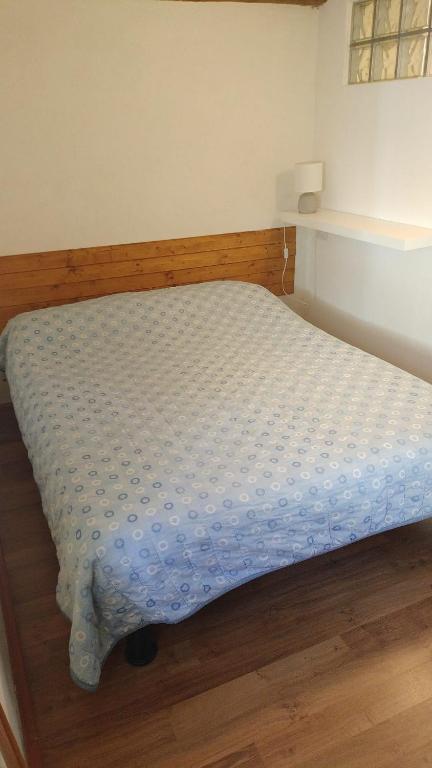 a bedroom with a bed with a blue comforter at Bianca in Premeno