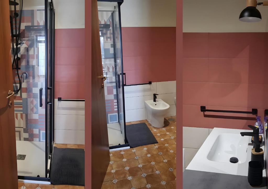a bathroom with a shower and a sink and a toilet at La Casa di Paddington in Piana di Caiazzo