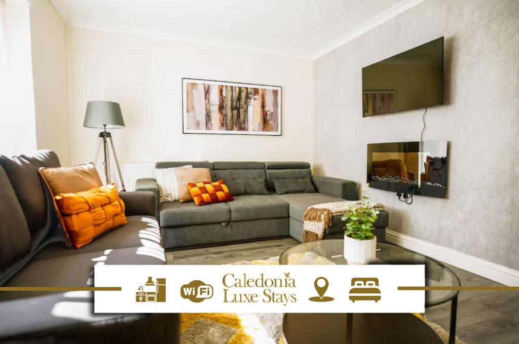 a living room with a couch and a tv at Bonkle House in Wishaw