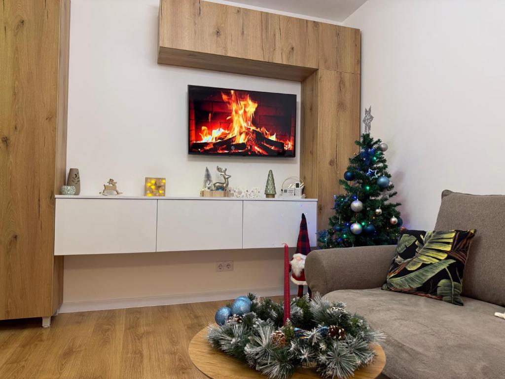 a living room with a christmas tree and a fireplace at Panoramic RESIDENCE in Baia Mare