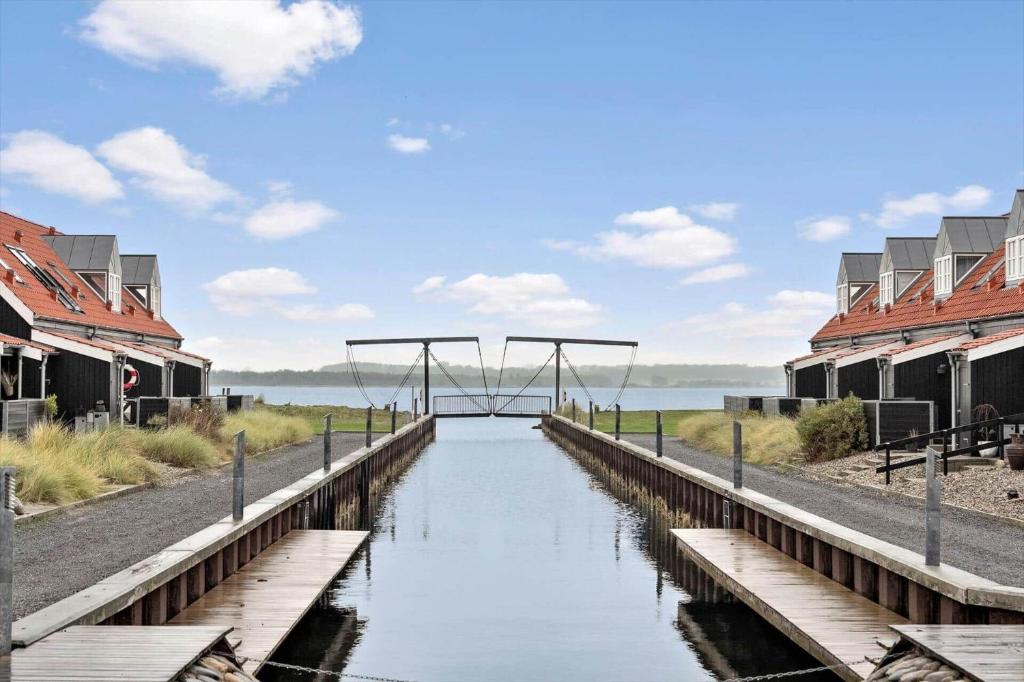 a wooden bridge over a canal with houses at 40173-juelsminde-Strandengen-46 in Juelsminde