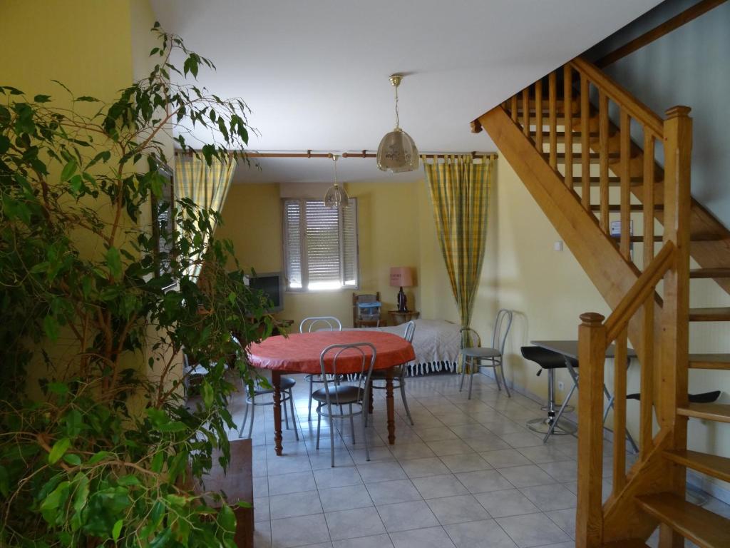 a kitchen and dining room with a table and chairs at Gîte Thevenin in Le Châtelet