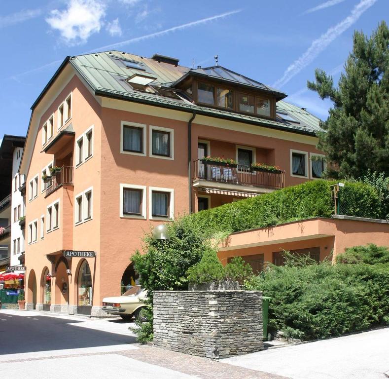a large orange building with a green roof at Kurapotheke in Bad Hofgastein