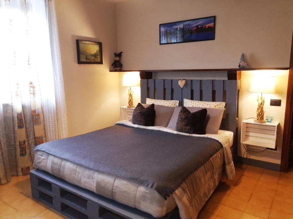 a bedroom with a large bed in a room at La maison de Carmen in Aosta