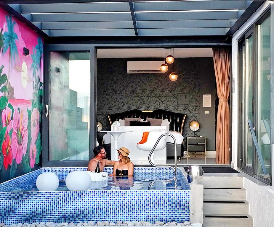 two women sitting in a bath tub in a bedroom at The View Luxe Boutique Hotel 