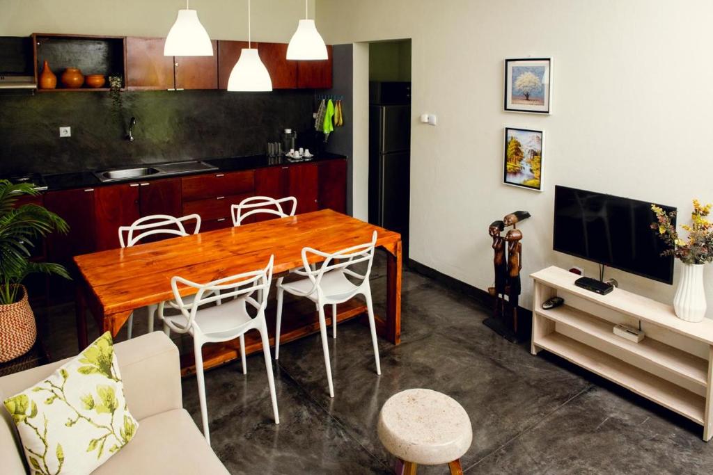 a living room with a wooden table and chairs at Lagoon Bay Chidenguele in Chidenguele