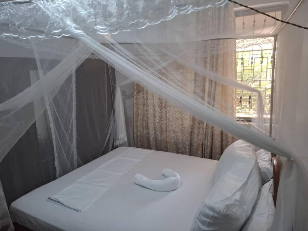 En eller flere senge i et værelse på P Square Apartment