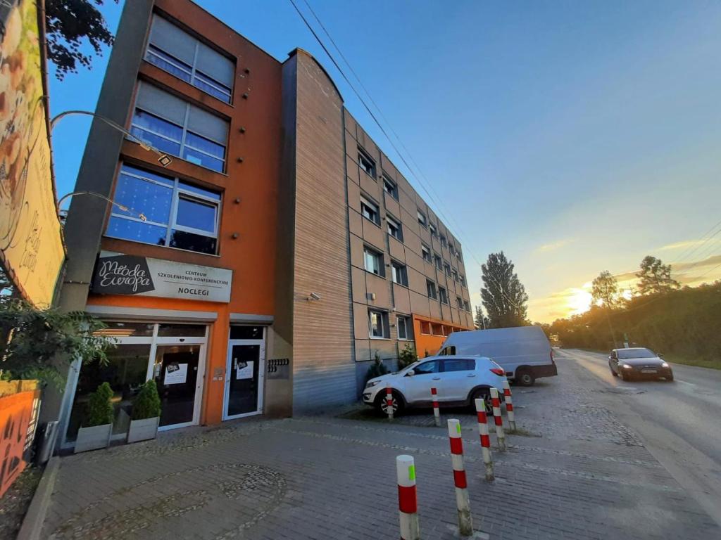 a car parked in a parking lot next to a building at Młoda Europa in Łódź