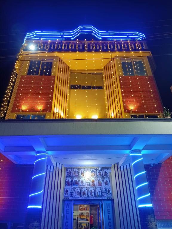 a building with blue lights on top of it at Paribartan Hotel & Lodge in Farakka
