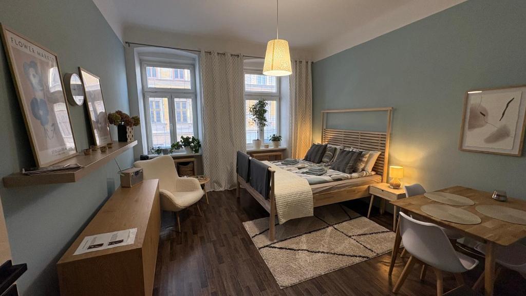 a living room with a bed and a table at Enjoy Wien in Vienna