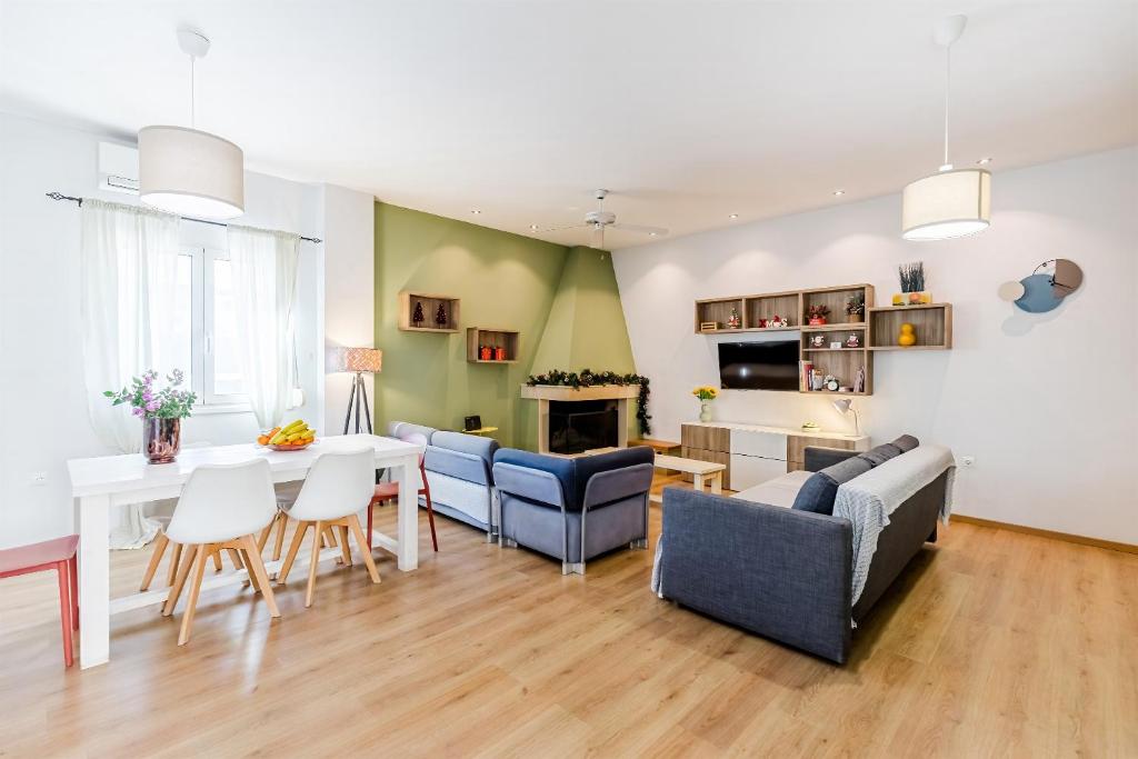 a living room with a table and chairs and a dining room at Monemvasia modern flat nearby sea in Monemvasia