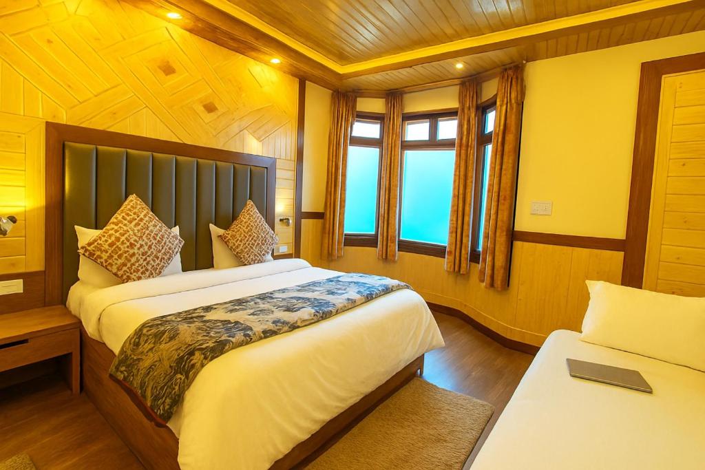 a bedroom with two beds and two windows at Naini Lake View The- Gwen -Stays Mall Road - Lake View Rooms Types- Prime Location - Best Luxuary Hotel In Nainital in Nainital