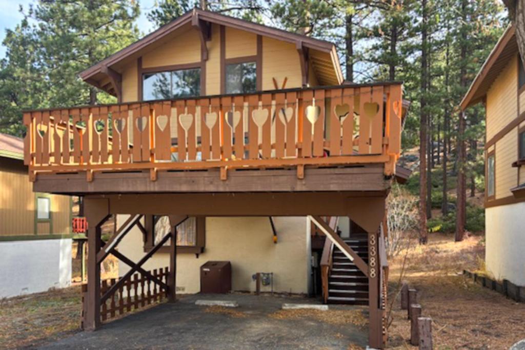 a house with a large deck on top of it at Pine Hill Hideaway in Stateline