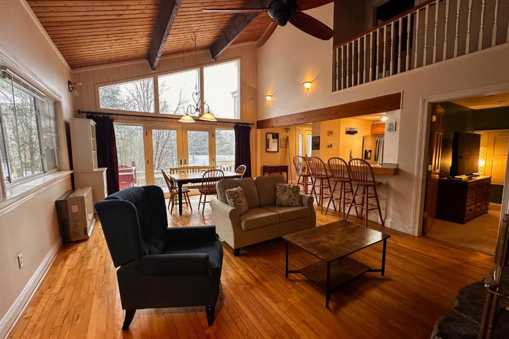 a living room with a couch and a table at Middle Pines Chalet in Warren