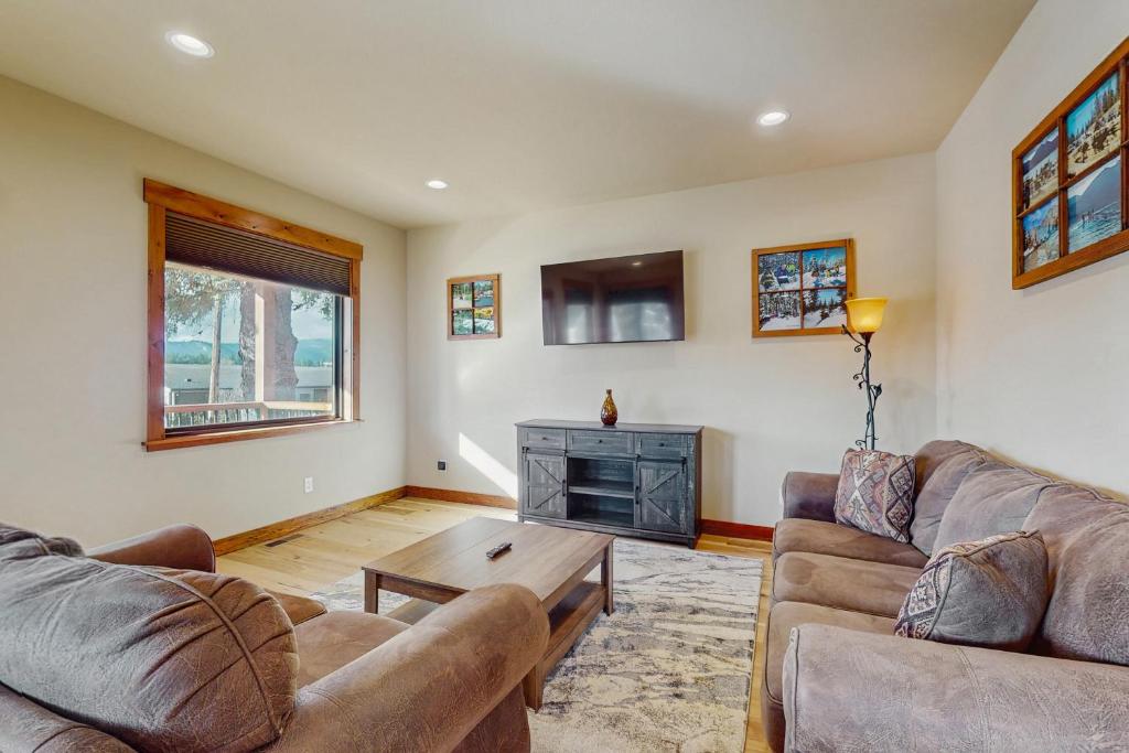 a living room with two couches and a coffee table at No. 3 Coal Mine Cabin in Ronald