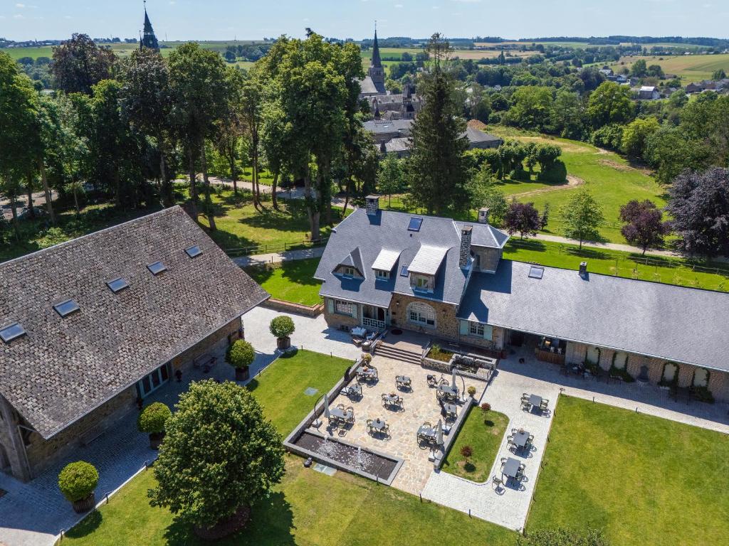 an aerial view of a large house with a yard at Auberge du chateau de Leignon in Leignon