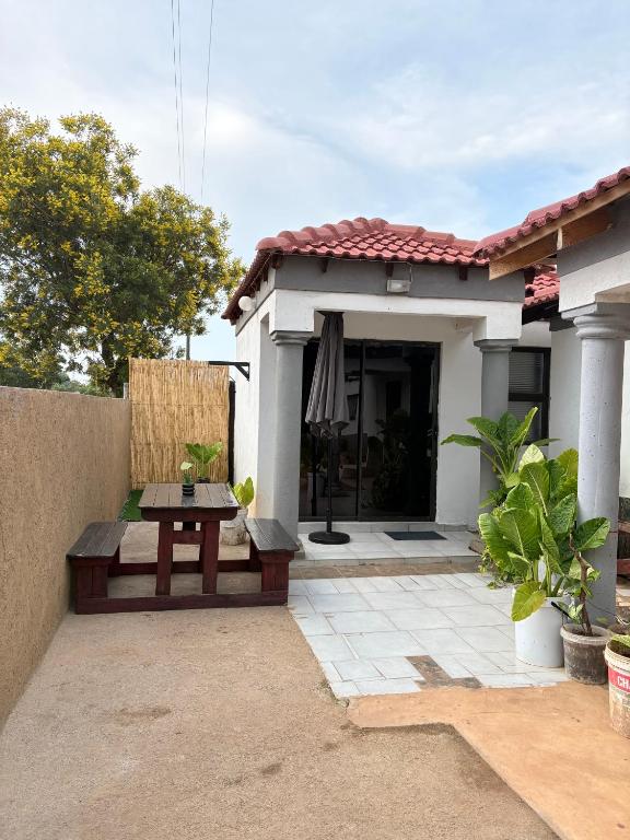 a small house with a table in front of it at Hlones place in Rustenburg