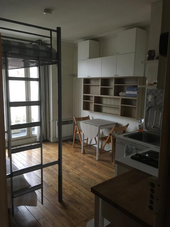 a kitchen and living room with a bunk bed at STUDIO Doré in Paris
