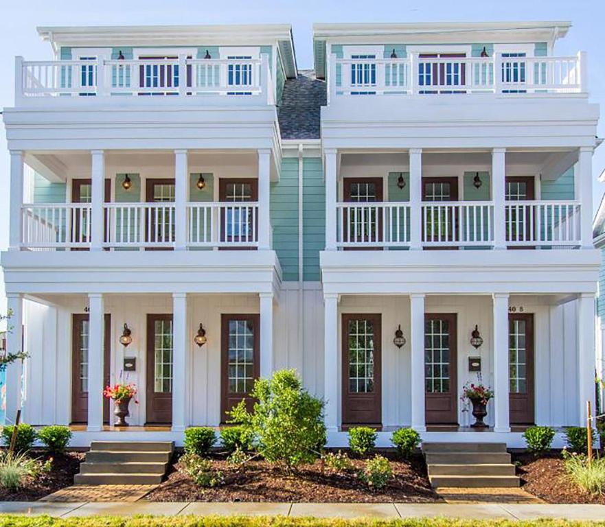 a large white house with a porch and stairs at 404B The Princess Anne House in Virginia Beach