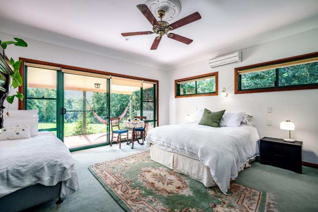 a bedroom with two beds and a ceiling fan at Evermoore Homestead in Gleniffer