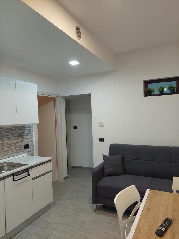 una sala de estar con un sofá y una mesa en Appartamento a MXP Aeroporto-Via Mameli, en Somma Lombardo