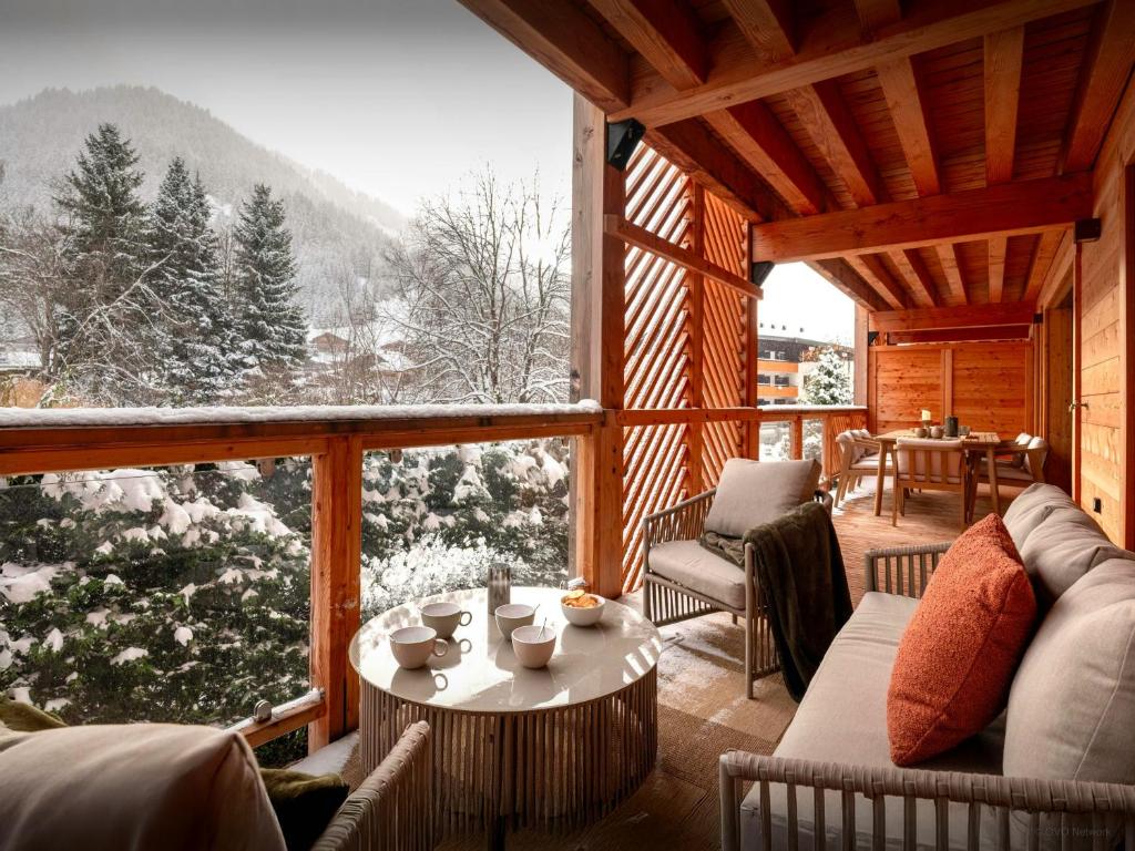 a living room with a view of a snowy mountain at Lodge Cresson - OVO Network in Châtel