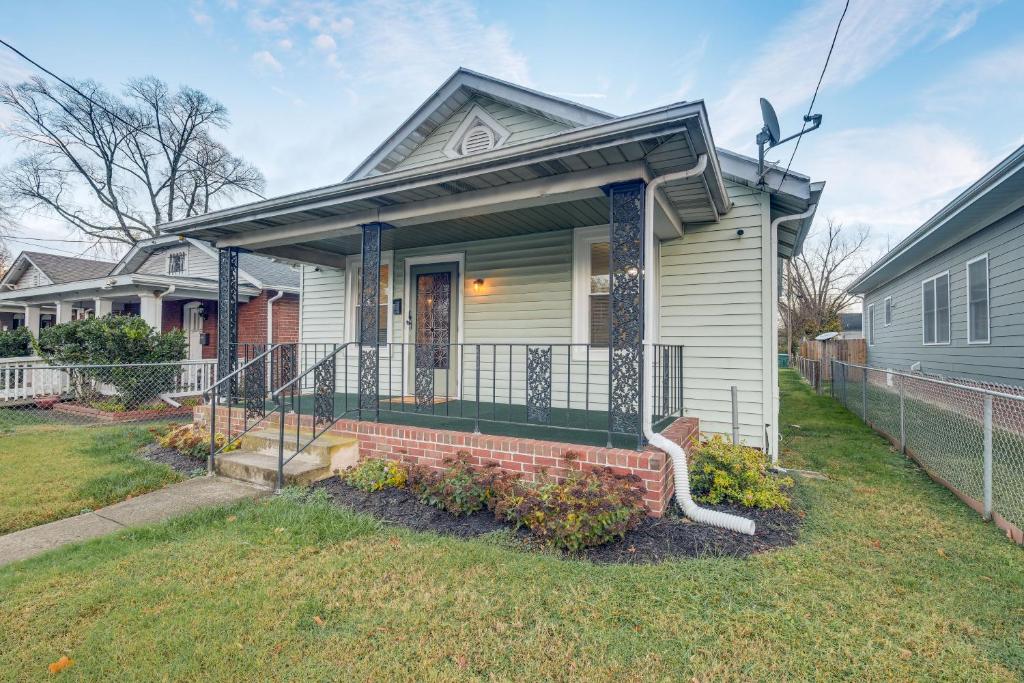 a house with a porch and a fence at Great for Long Stays! RVA Home with Yard Near Dtwn in Richmond