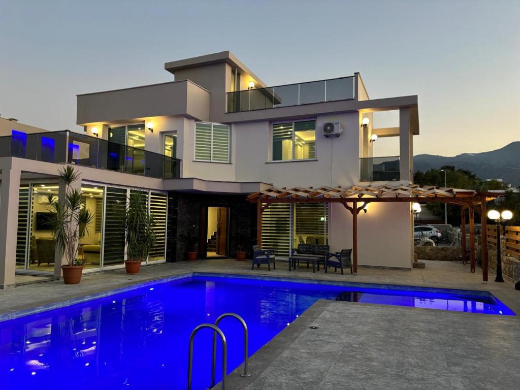 a house with a swimming pool in front of it at Veray Homes Villa in Ayios Dhometios