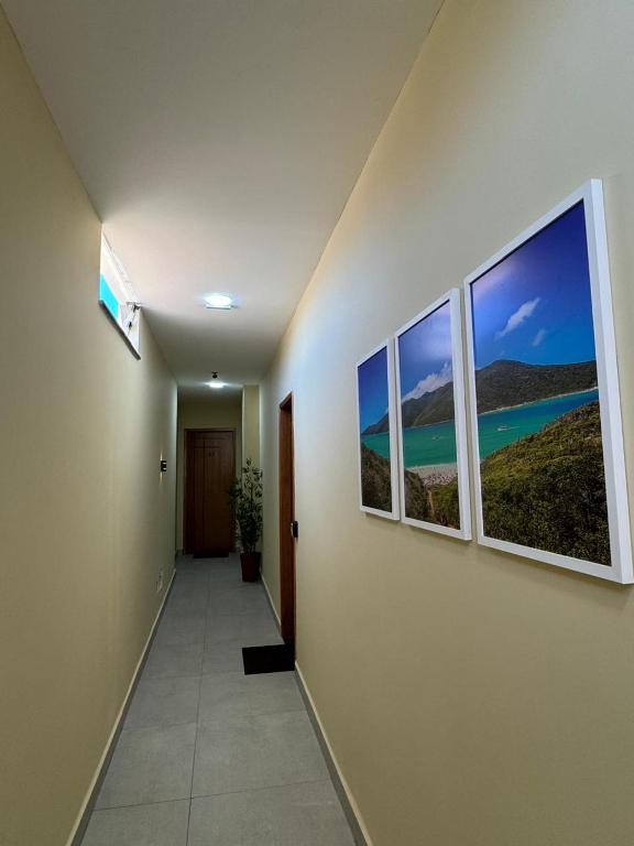 a hallway with three windows in a building at Hey Mar Suites in Arraial do Cabo