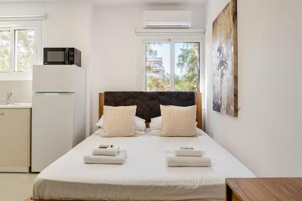 a bedroom with a large bed with two towels on it at Urban Bay Studios in Limassol