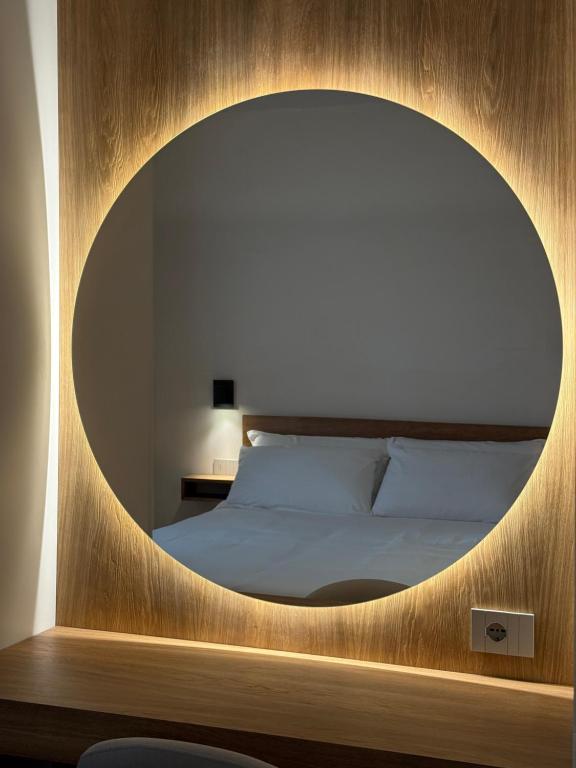 una camera da letto con un grande specchio su un letto di BORGO COMPAGNIA Porta Fredda a Castiglion Fibocchi
