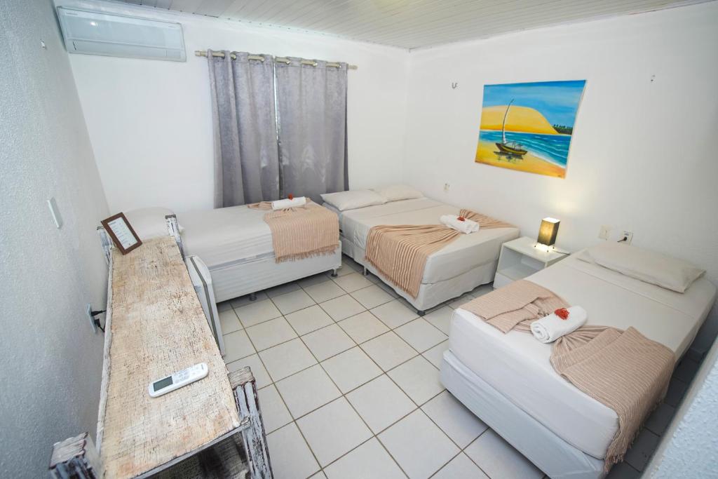 Ένα ή περισσότερα κρεβάτια σε δωμάτιο στο Pousada Hippopotamus Jeri