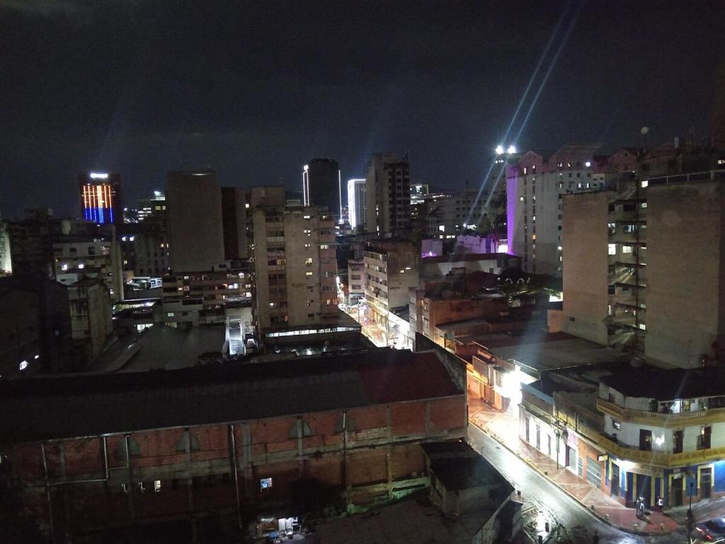a city at night with buildings and lights at Comfortable Independent Apartment Downtown Ccs in Caracas